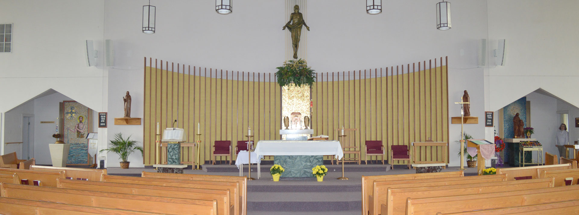 The sanctuary of Saint Anne Church, with the altar, ambo, and risen Christ figure above.